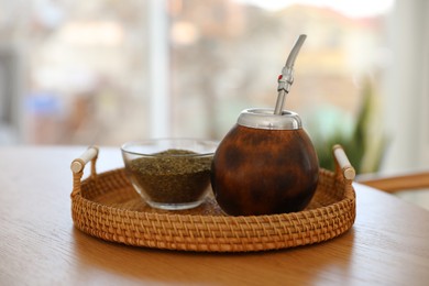 Photo of Traditional yerba mate tea on wooden table indoors