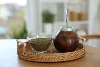 Photo of Traditional yerba mate tea on wooden table indoors
