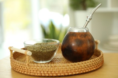 Photo of Traditional yerba mate tea on wooden table indoors, closeup
