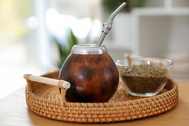 Photo of Traditional yerba mate tea on wooden table indoors, closeup