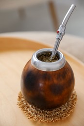 Photo of Traditional yerba mate tea on table indoors, closeup