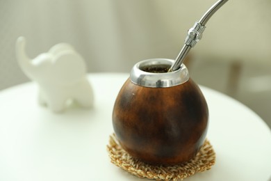 Photo of Traditional yerba mate tea on white table indoors, closeup