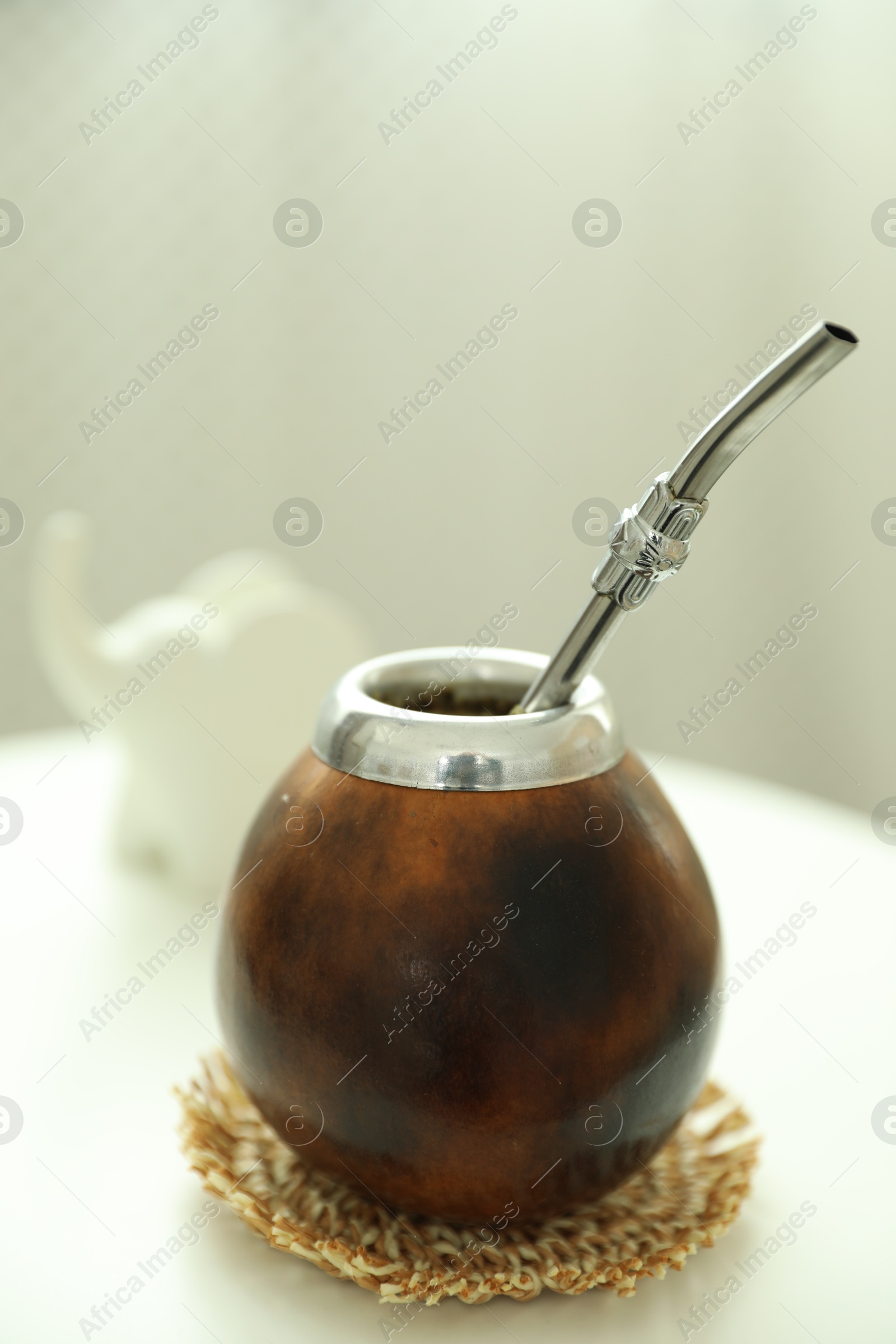 Traditional yerba mate tea on white table indoors, closeup Photo of Traditional yerba mate tea on white table indoors, closeup