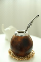 Photo of Traditional yerba mate tea on white table indoors, closeup