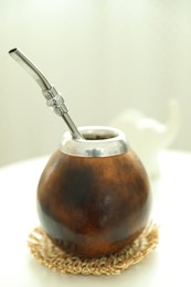 Photo of Traditional yerba mate tea on white table indoors, closeup