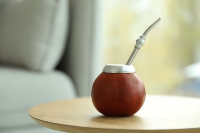 Photo of Traditional yerba mate tea on wooden table indoors