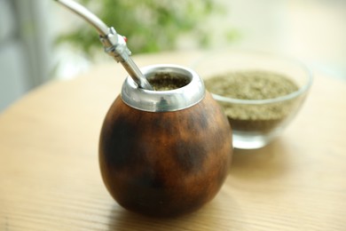Photo of Traditional yerba mate tea on wooden table, closeup