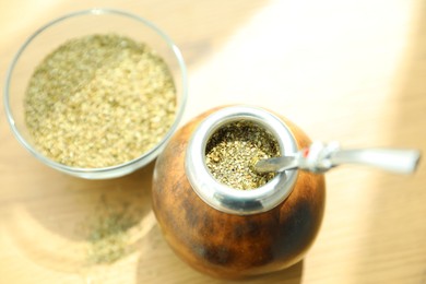Photo of Traditional yerba mate tea on wooden table, above view