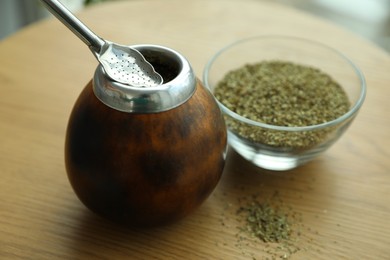 Photo of Traditional yerba mate tea on wooden table, closeup