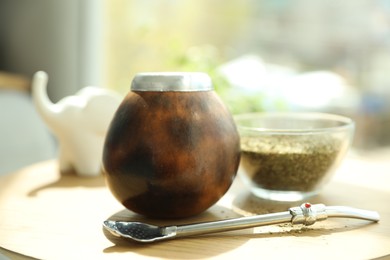 Photo of Traditional yerba mate tea on wooden table indoors, closeup