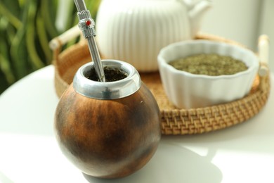 Photo of Traditional yerba mate tea on white table indoors, closeup