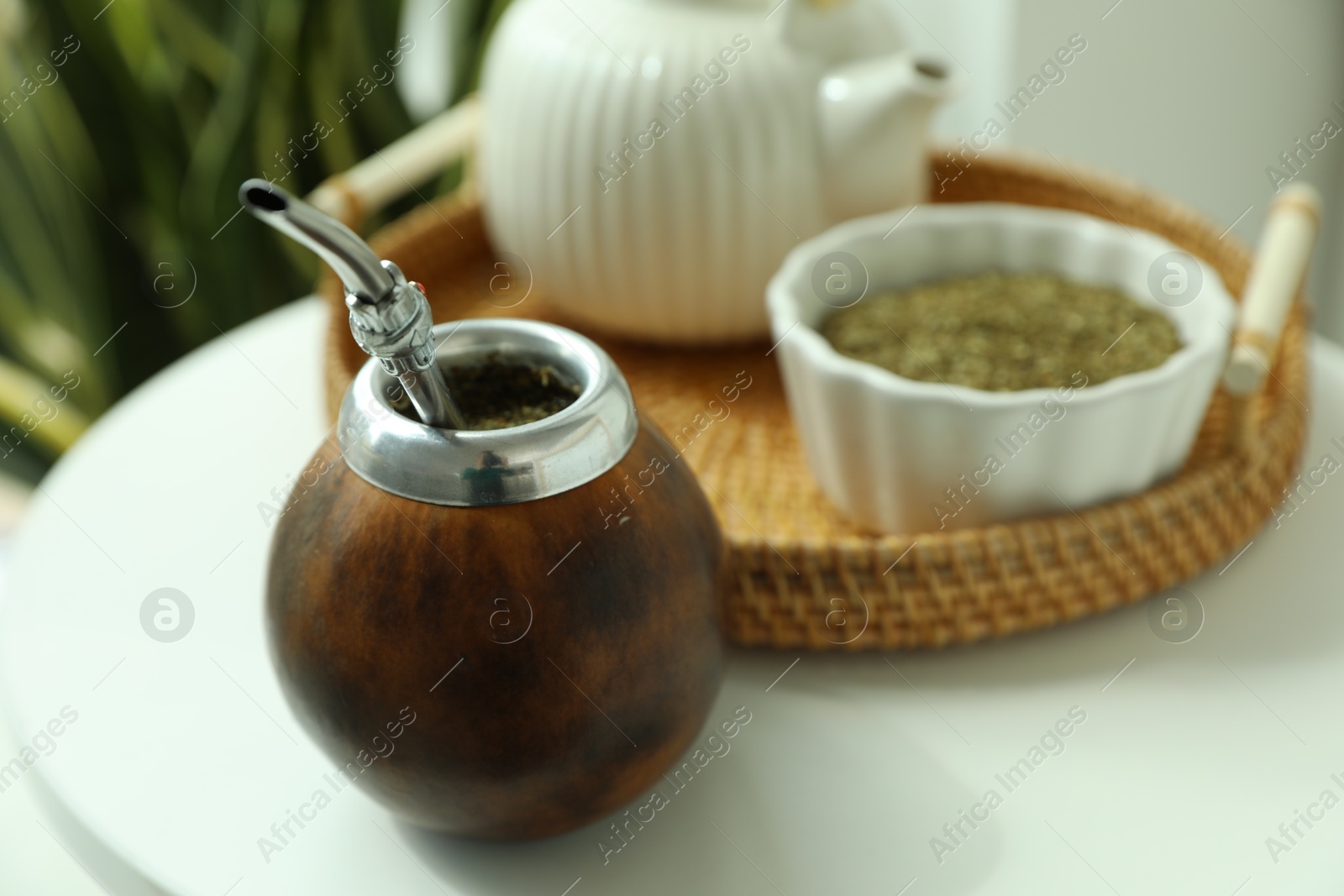 Traditional yerba mate tea on white table indoors, closeup Photo of Traditional yerba mate tea on white table indoors, closeup