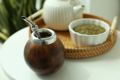 Photo of Traditional yerba mate tea on white table indoors, closeup