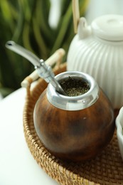 Photo of Traditional yerba mate tea on table, closeup