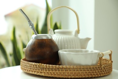 Photo of Traditional yerba mate tea on white table indoors, closeup