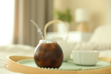 Photo of Traditional yerba mate tea on bed indoors