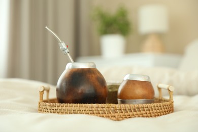 Photo of Traditional yerba mate tea on bed indoors
