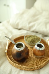 Photo of Traditional yerba mate tea on bed indoors
