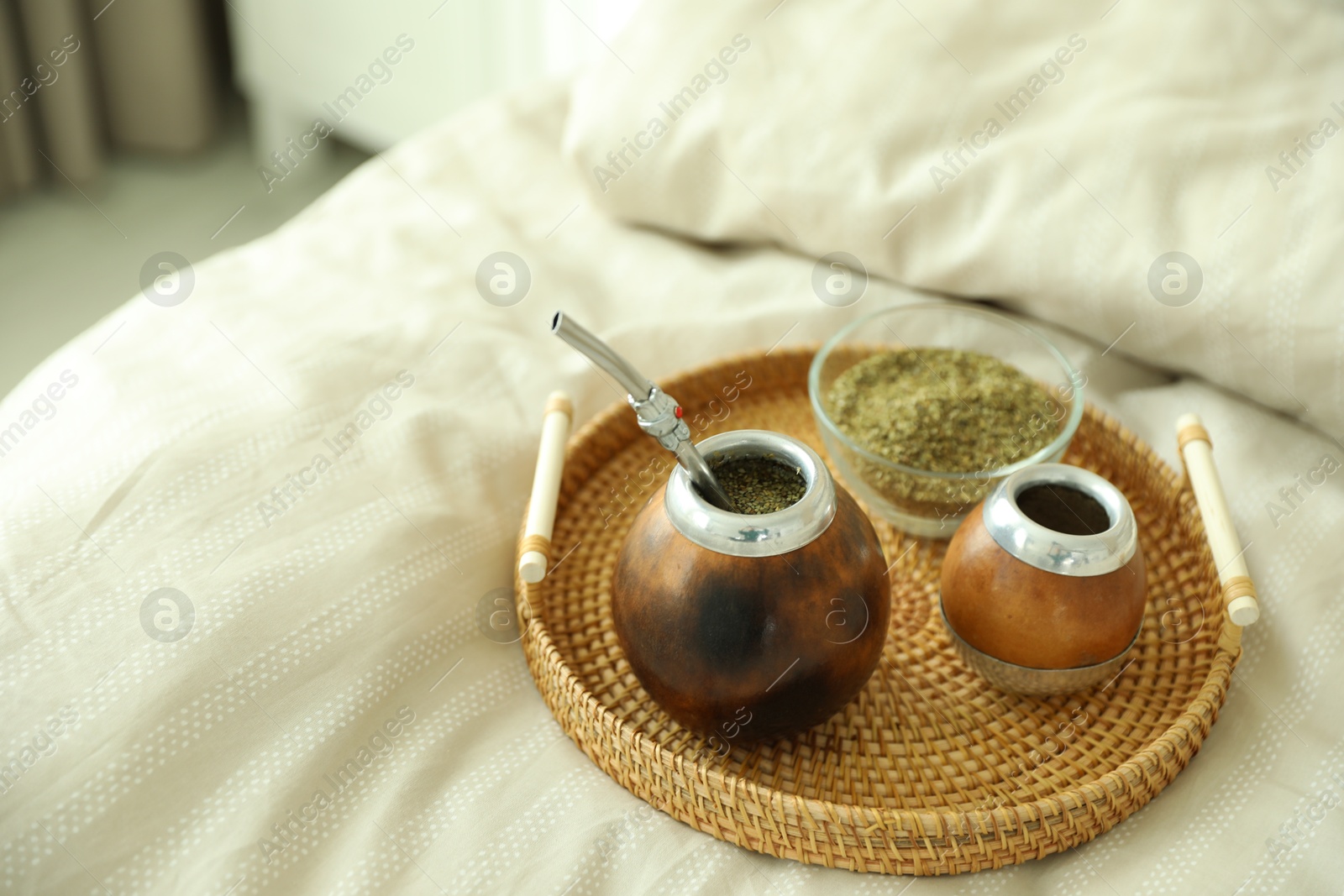 Traditional yerba mate tea on bed indoors Photo of Traditional yerba mate tea on bed indoors