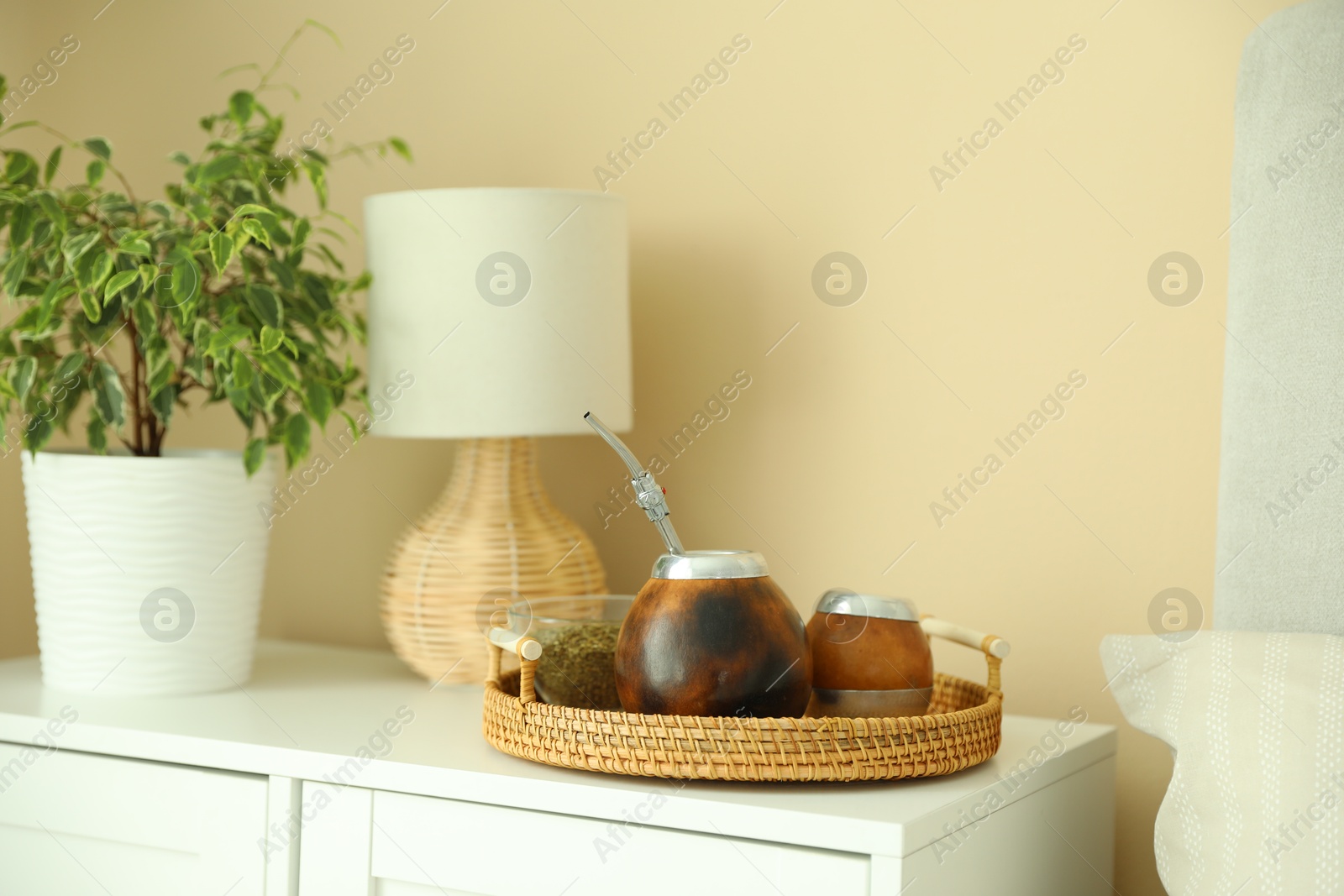 Traditional yerba mate tea on nightstand indoors Photo of Traditional yerba mate tea on nightstand indoors