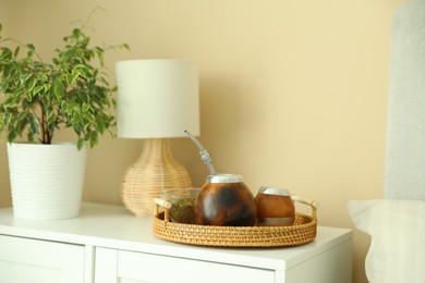 Photo of Traditional yerba mate tea on nightstand indoors