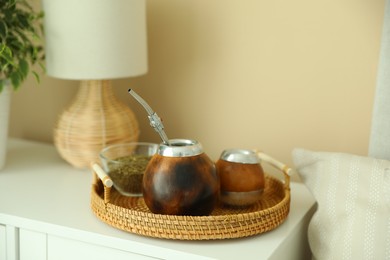 Photo of Traditional yerba mate tea on nightstand indoors