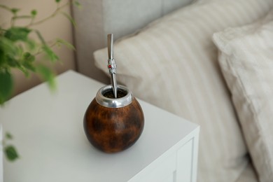 Photo of Traditional yerba mate tea on bedside table indoors