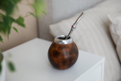 Photo of Traditional yerba mate tea on bedside table indoors