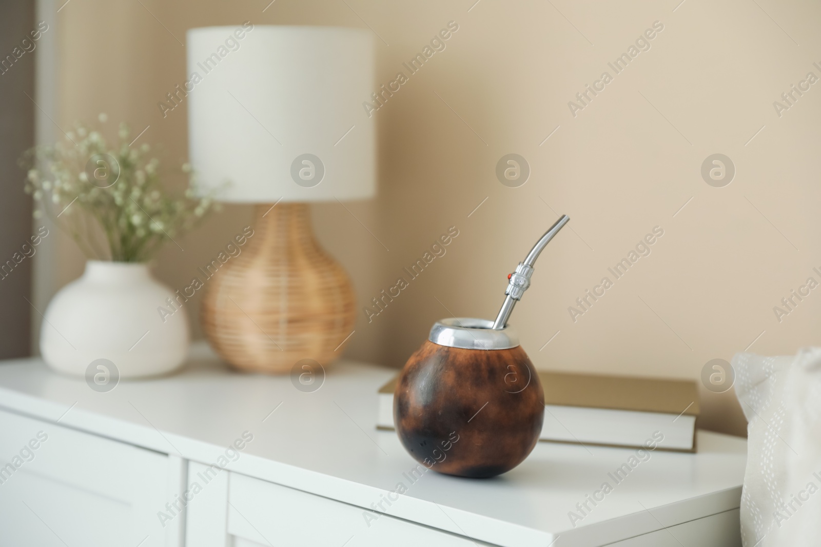 Traditional yerba mate tea on nightstand indoors Photo of Traditional yerba mate tea on nightstand indoors