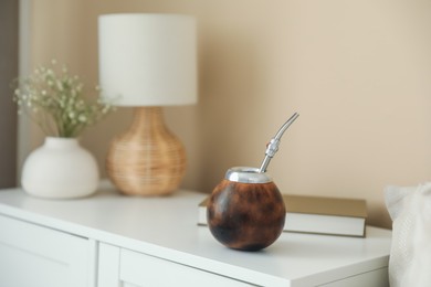 Photo of Traditional yerba mate tea on nightstand indoors