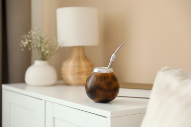 Photo of Traditional yerba mate tea on nightstand indoors