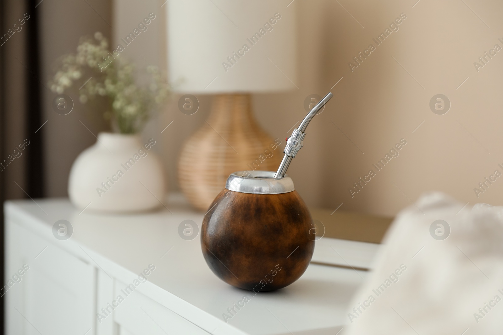 Traditional yerba mate tea on nightstand indoors Photo of Traditional yerba mate tea on nightstand indoors
