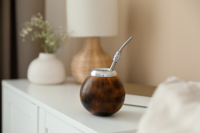 Photo of Traditional yerba mate tea on nightstand indoors