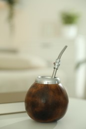 Photo of Traditional yerba mate tea on white table indoors