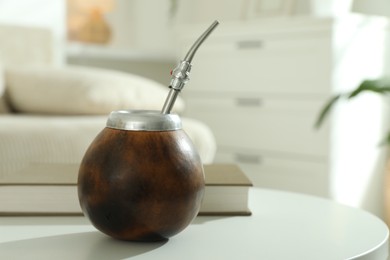 Photo of Traditional yerba mate tea on white table indoors