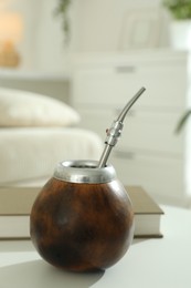 Photo of Traditional yerba mate tea on white table indoors