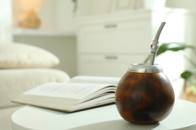 Photo of Traditional yerba mate tea on white table indoors