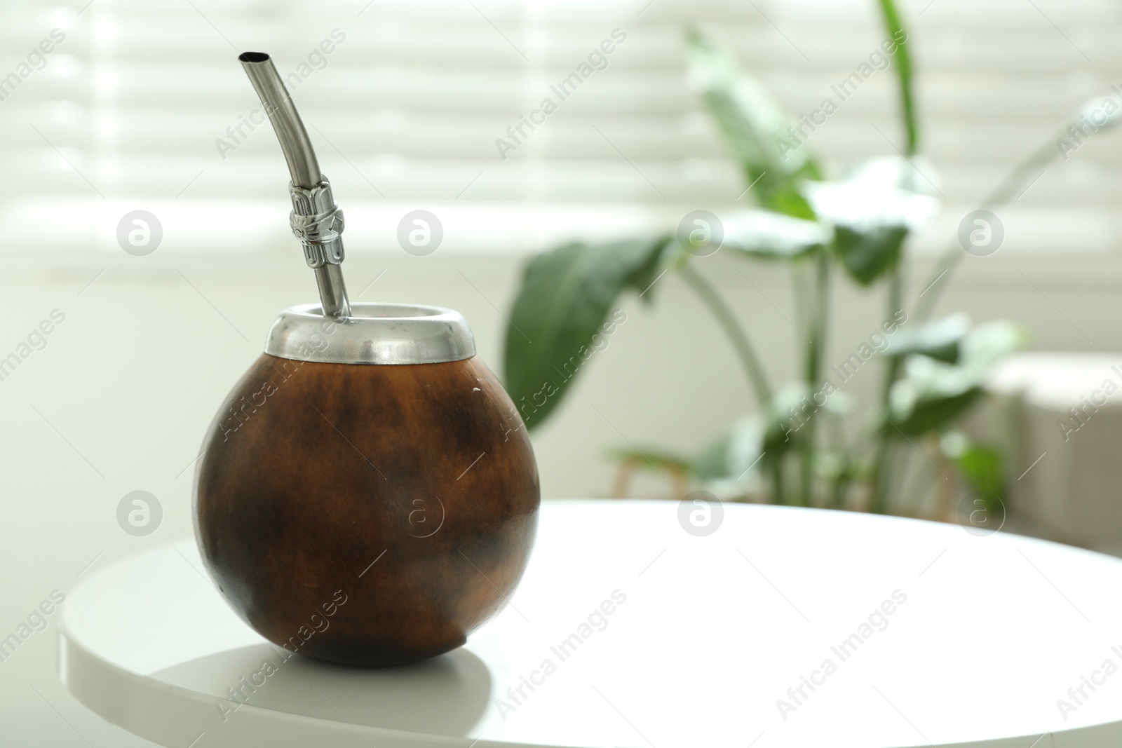 Traditional yerba mate tea on white table indoors, space for text Photo of Traditional yerba mate tea on white table indoors, space for text