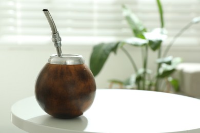 Photo of Traditional yerba mate tea on white table indoors, space for text