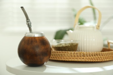 Photo of Traditional yerba mate tea on white table indoors
