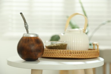 Photo of Traditional yerba mate tea on white table indoors