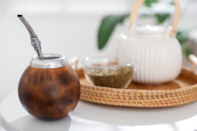 Photo of Traditional yerba mate tea on white table indoors, closeup