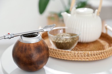 Photo of Traditional yerba mate tea on white table indoors, closeup