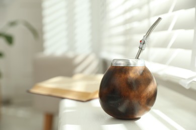 Photo of Traditional yerba mate tea on windowsill indoors, closeup