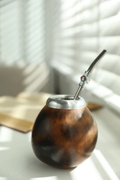 Photo of Traditional yerba mate tea on white table indoors