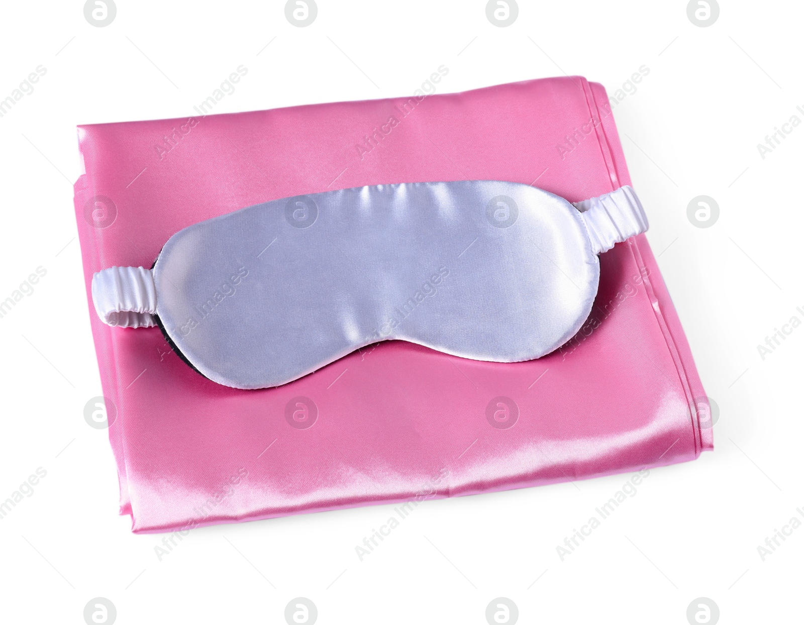 Silky bed linens and sleeping mask on white background Photo of Silky bed linens and sleeping mask on white background