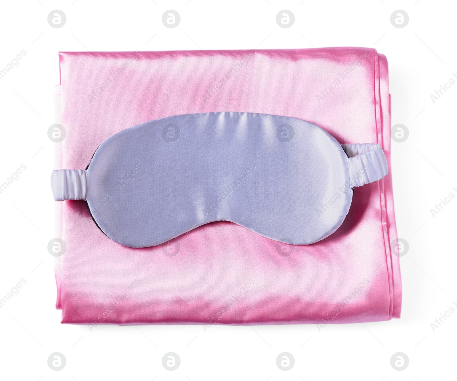 Silky bed linens and sleeping mask on white background, top view Photo of Silky bed linens and sleeping mask on white background, top view
