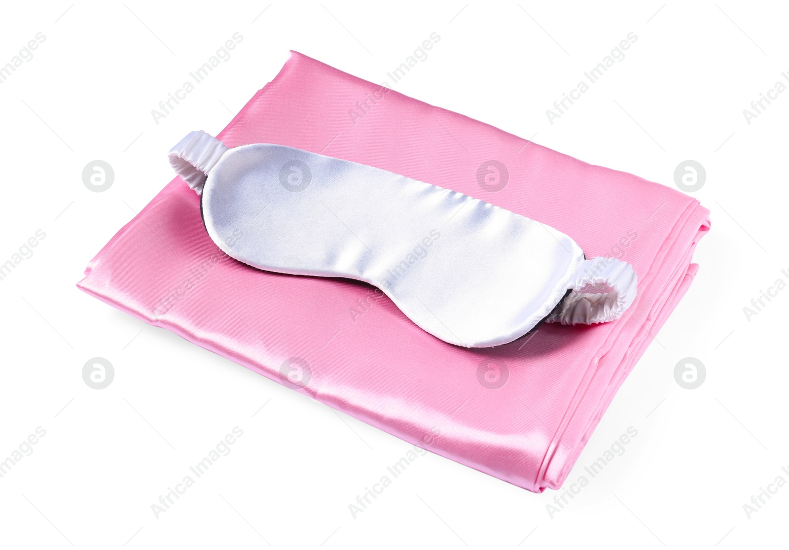 Silky bed linens and sleeping mask on white background Photo of Silky bed linens and sleeping mask on white background
