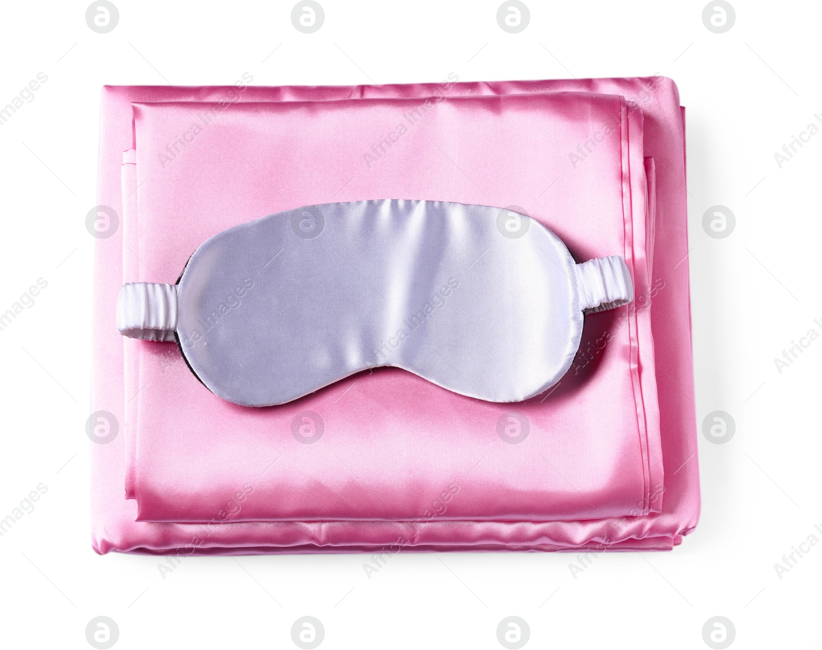 Silky bed linens and sleeping mask on white background, top view Photo of Silky bed linens and sleeping mask on white background, top view
