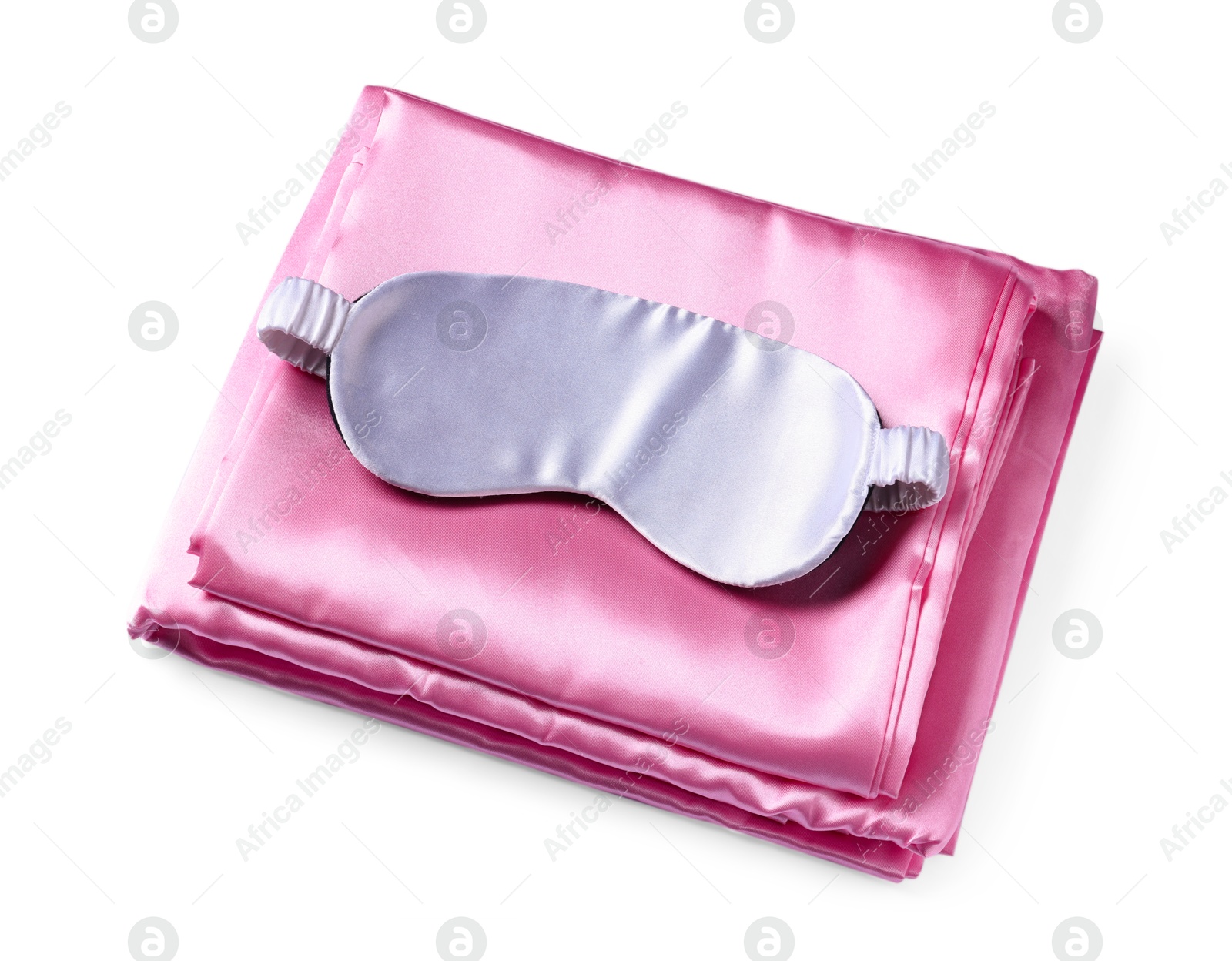 Silky bed linens and sleeping mask on white background Photo of Silky bed linens and sleeping mask on white background